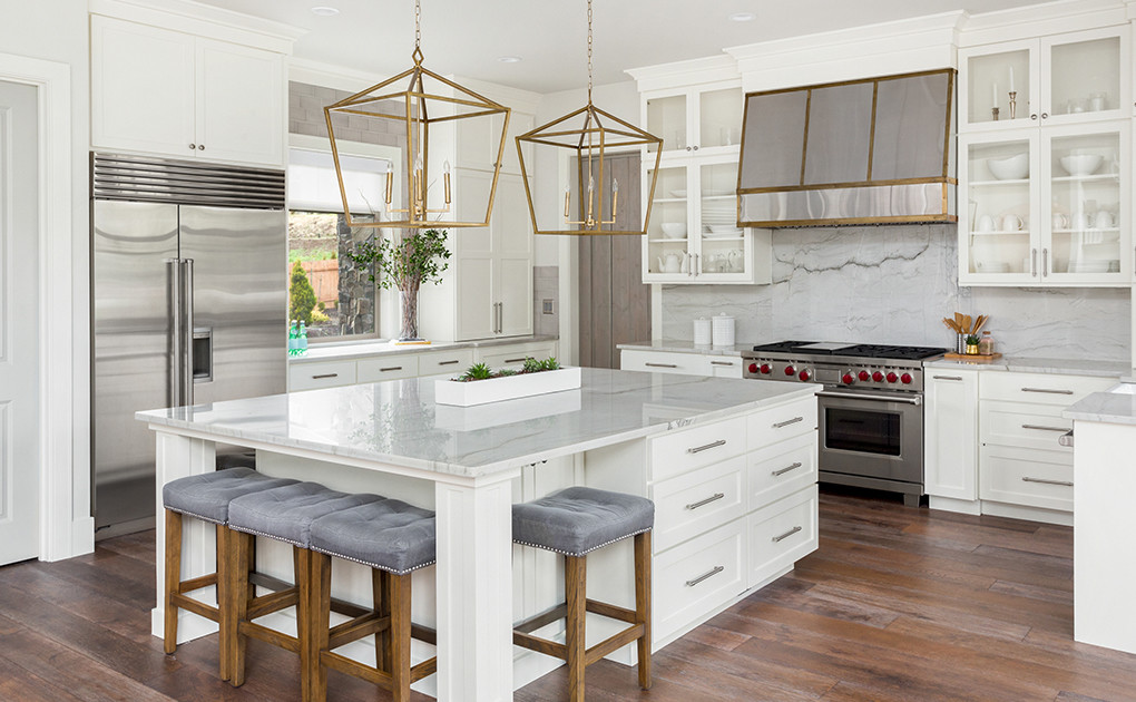 Modern Kitchen with white cabinets and gold accents